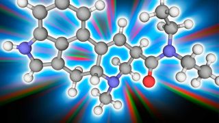 Das Titelbild des Beitrags zeigt Moleküle - also Kugeln in verschiedenen Farben, die durch Stäbchen miteinander verbunden sind. Im Hintergrund sind Strahlen in verschiedenen Farben zu sehen.
